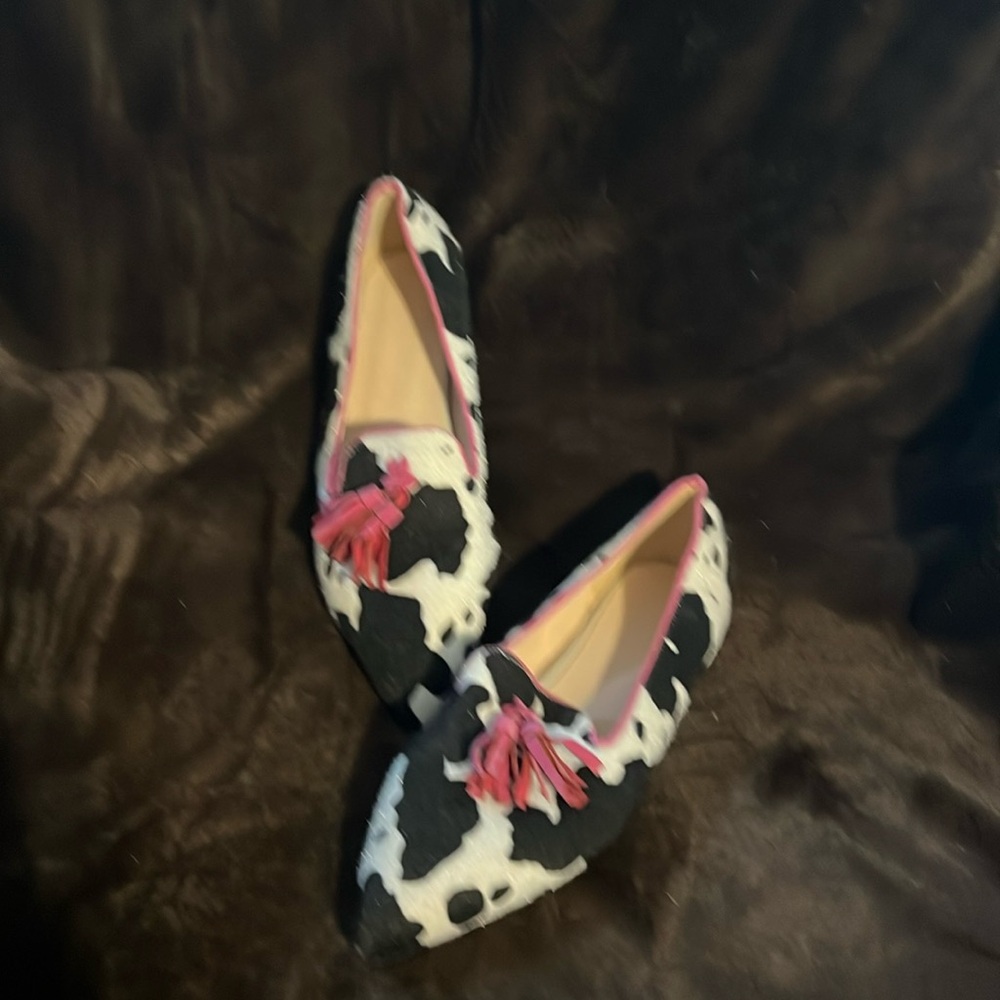 Black and white cow print haircalf flats with pink accent